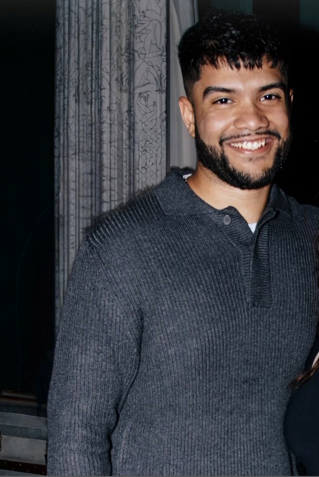 Velozi Credit co-founder smiling in a gray knit sweater