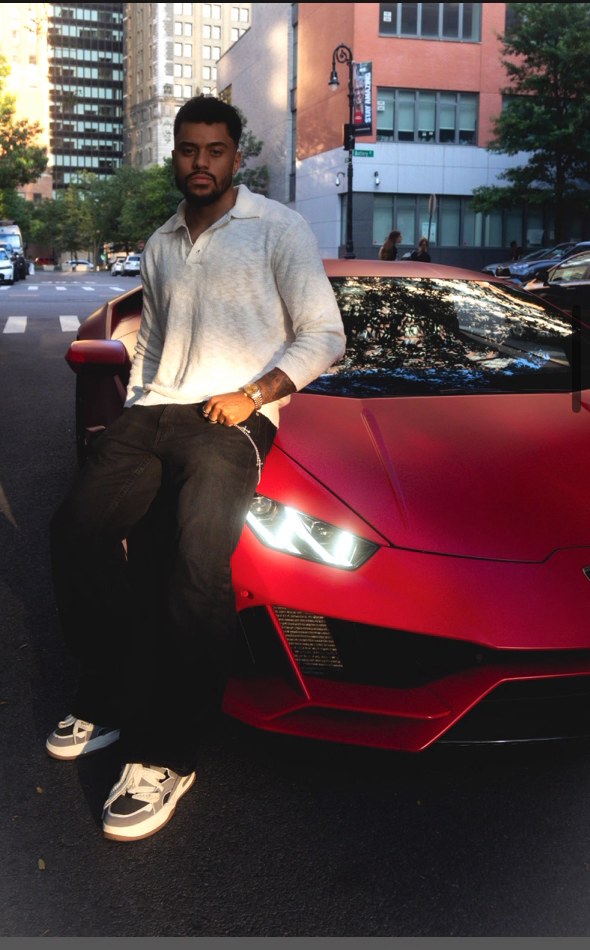 Velozi Credit co-founder sitting on a red sports car in the city